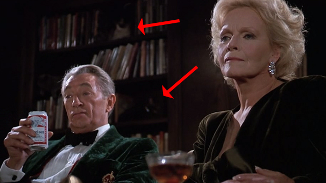 Scrooged - Preston Rhinelander Robert Mitchum and Maria Riva with cats on bookcase behind them