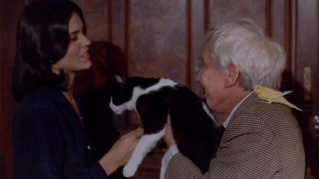 The Sentinel - Charles Chazen Burgess Meredith holding tuxedo cat Jezebel out to Alison Parker Cristina Raines with Mortimer the parakeet