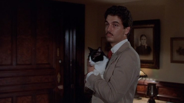 The Sentinel - Michael Chris Sarandon holding tuxedo cat Jezebel