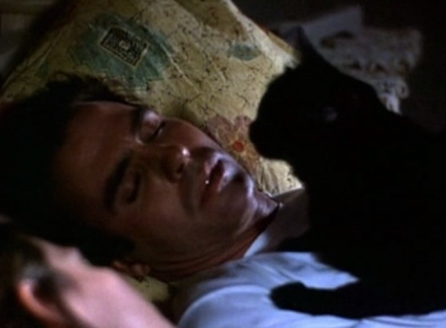 Serpent's Lair - black cat lying on Tom Jeff Fahey in bed