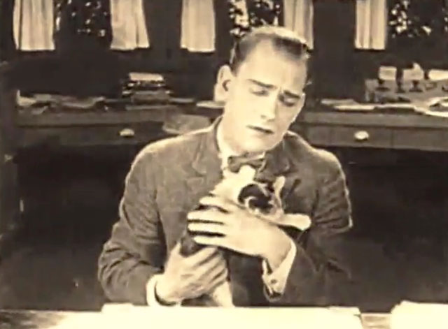 The Shock - Wilse Dilling Lon Chaney holding calico kitten at desk