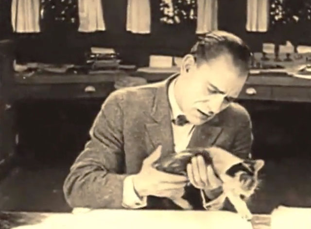 The Shock - Wilse Dilling Lon Chaney setting calico kitten onto desk