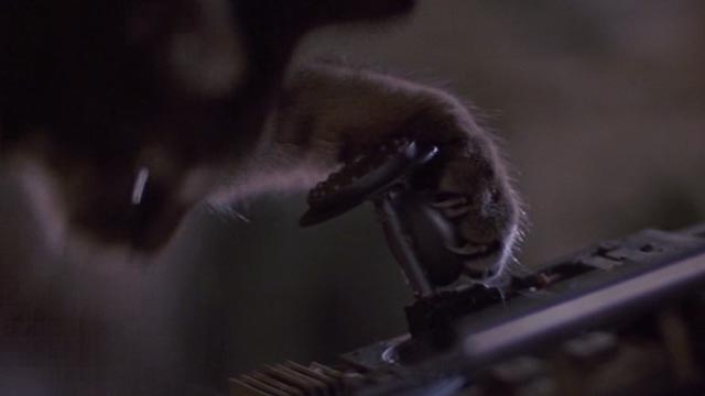 Short Circuit 2 - tabby cat paw hits Johnny 5 robot's control