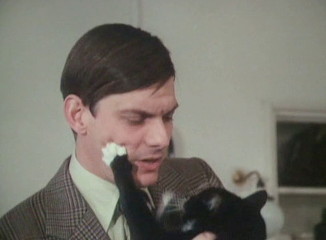 It Shouldn't Happen to a Vet - tuxedo cat Seven Times Three pawing at Carmody Paul Shelley face