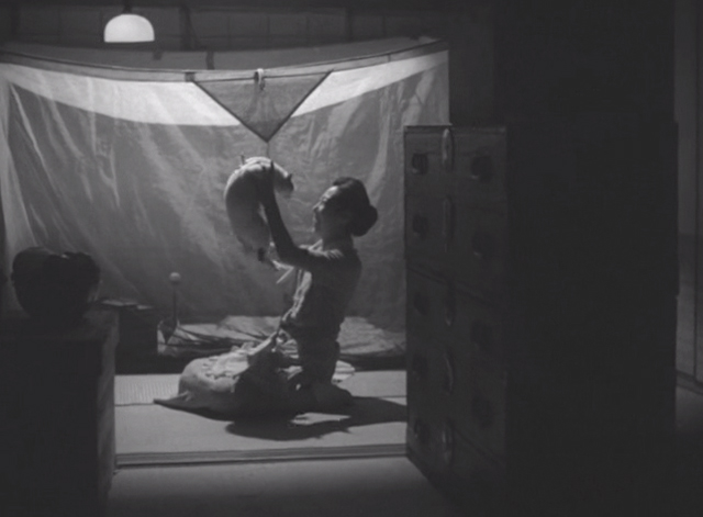 Shozo, a Cat and Two Women - Shinako Isuzu Yamada holding up white and calico cat Lily