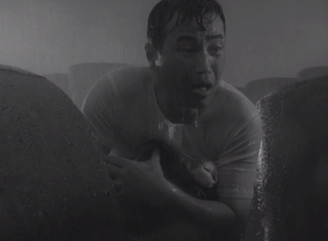 Shozo, a Cat and Two Women - Shozo Hisaya Morishige holding white and calico cat Lily in rain