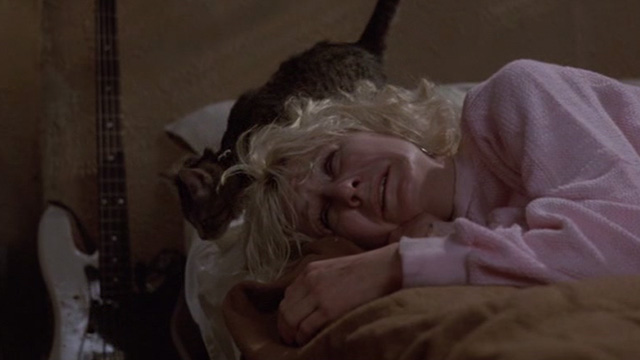 Sid and Nancy - Nancy Chloe Webb crying on bed with tabby kitten behind her