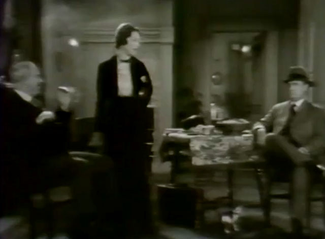 Silence - calico kitten on carpeted floor beneath Norma Peggy Shannon and policemen