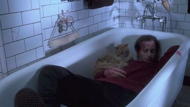 Single White Female - Graham Peter Friedman lying unconscious in bathtub with long haired ginger tabby cat Carmen
