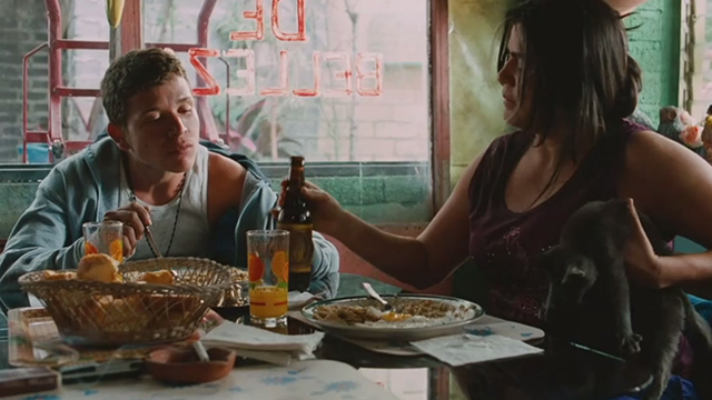 Sin Nombre - Willy Edgar Flores looking at Aunt holding gray cat at table