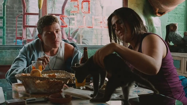 Sin Nombre - Willy Edgar Flores looking Aunt setting gray cat on table