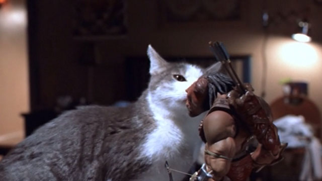 Small Soldiers - gray and white tabby cat sniffing at Archer toy Gorgonite