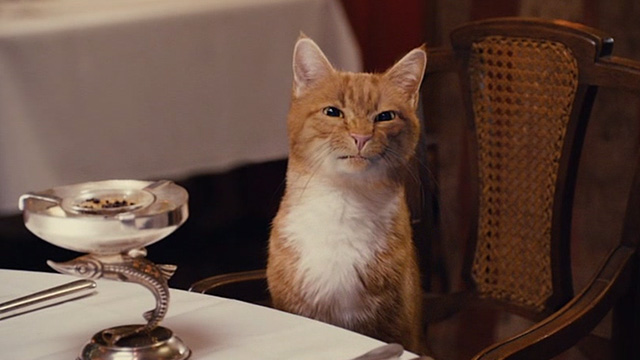 The Smurfs movie - Azrael cat looking disgusted at table in restaurant