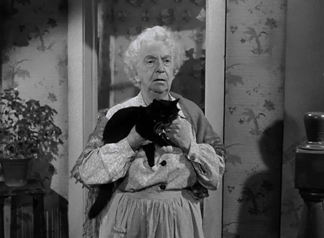 The Sniper - landlady Mabel Paige carrying tuxedo cat Asa