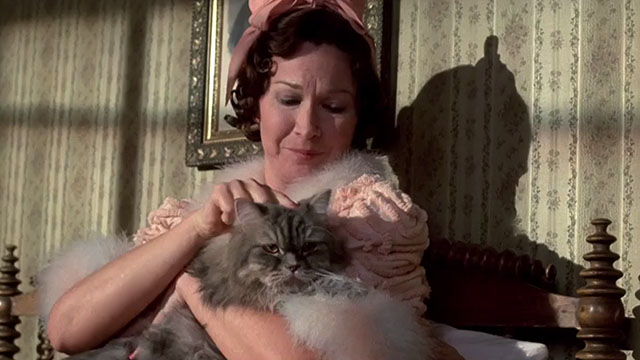 Something Wicked This Way Comes - Mrs. Nightshade Diane Ladd holding grey longhair tabby cat in bed