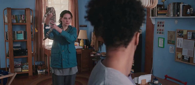 Sorry, Baby - Agnes Eva Victor holding up gray tabby kitten Olga Noochie to show Lydie Naomi Ackie