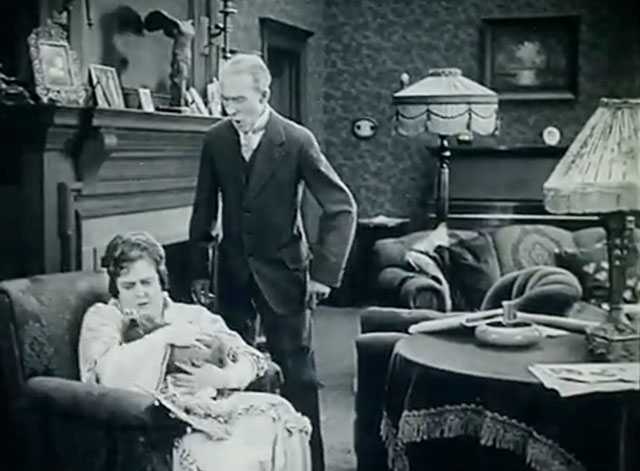 The Soul of Youth - Mrs. Hodge Sylvia Ashton cradling longhair gray cat Babe by scruff with Mr. Hodge Fred Huntley