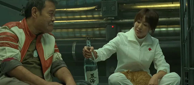 Space Battleship Yamato - Dr. Sado Reiko Takashima with ginger and white tabby cat on lap pouring sake for Tokugawa Toshiyuki Nishida