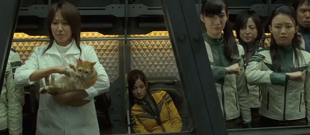 Space Battleship Yamato - Dr. Sado Reiko Takashima holding ginger and white tabby cat on escape craft in front of Yuki Meisa Kuroki