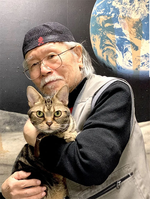 Space Battleship Yamato - artist Leiji Matsumoto holding brown tabby cat