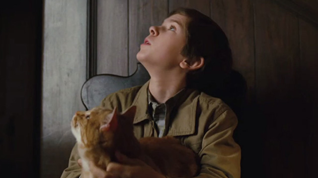 The Spiderwick Chronicles - orange tabby cat Tibbs with Simon Freddie Highmore on chair