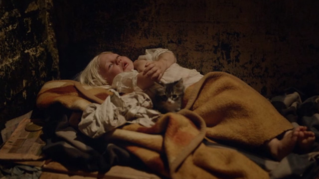 The Square - poor homeless little girl lying with kitten