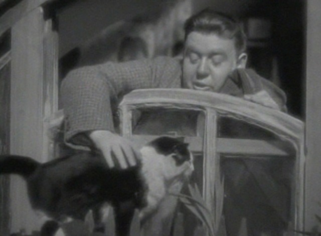 St. Martin's Lane - Charles pets black and white cat at window