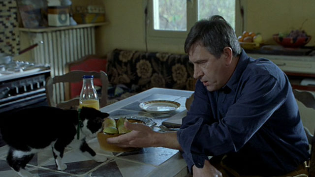 Histoire de Marie et Julien - The Story of Marie and Julien - Jerzy Radziwilowicz with tuxedo cat Nevermore Gaspard on table