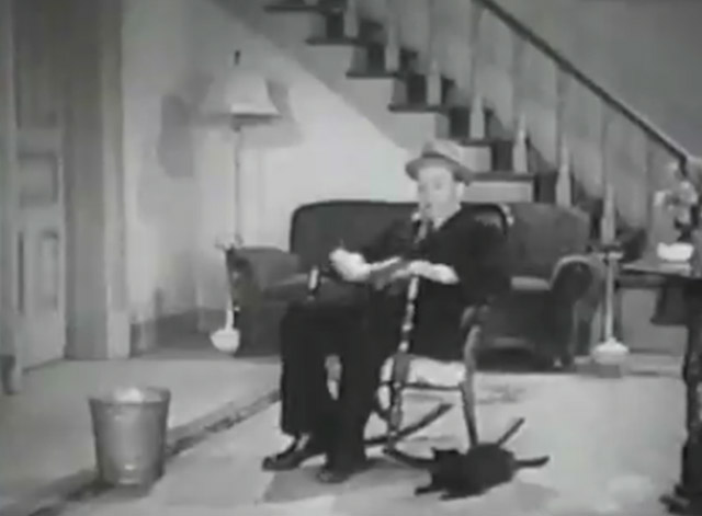 Sue My Lawyer - Harry Langdon sitting in rocking chair with black cat beside him on floor