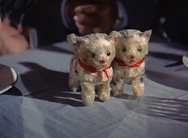 Summertime - pair of cat wind up toys on table