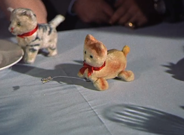 Summertime - cat chasing butterfly wind up toy on table