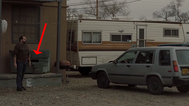 Sunshine Cleaning - black cat sitting on couch outside hotel