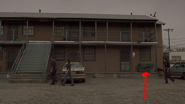 Sunshine Cleaning - black cat sitting on couch outside hotel long shot