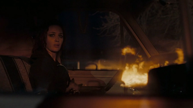 Sunshine Cleaning - Norah Emily Blunt holding Siamese kitten in lap in van while house burns