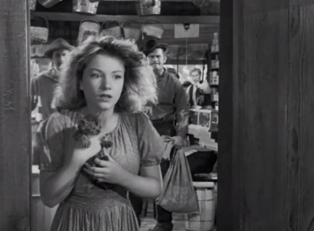 Swamp Water - Julie Anne Baxter holding tabby kitten in doorway of general store