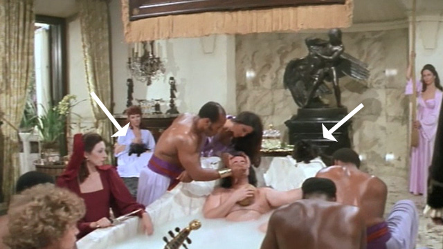 Swashbuckler - long haired black cats and women in background while Lord Durant Peter Boyle takes a bath