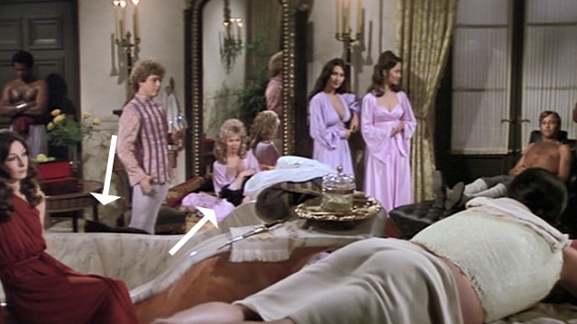 Swashbuckler - long haired black cats and women in background while Lord Durant Peter Boyle gets waxed