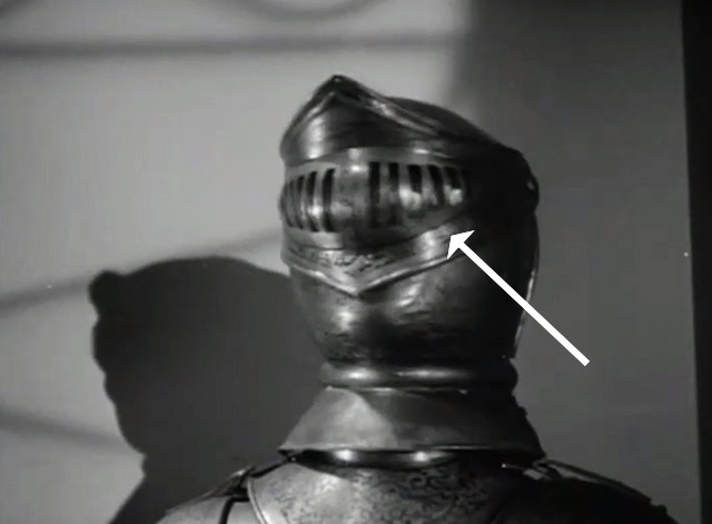 There's That Woman Again - glowiong cat's eyes visible behind visor of suit of armor
