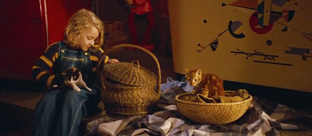 The Thief Lord - Bo Jasper Harris holding calico kitten with ginger tabby kitten nearby