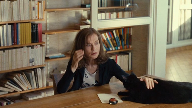 Things to Come - black cat Pandora still on table beside Nathalie Isabelle Huppert