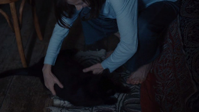 Things to Come - black cat Pandora being picked up by Nathalie Isabelle Huppert