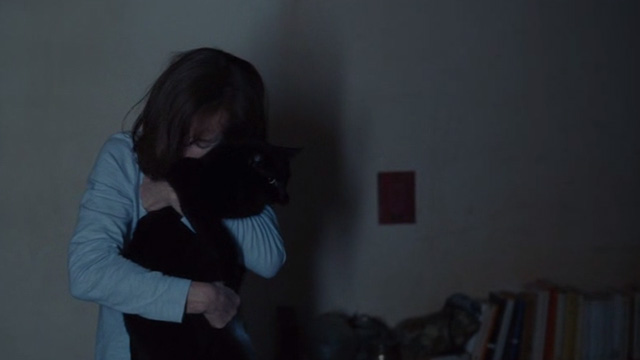 Things to Come - black cat Pandora being hugged by Nathalie Isabelle Huppert