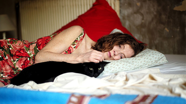 Things to Come - black cat Pandora lying on bed with Nathalie Isabelle Huppert