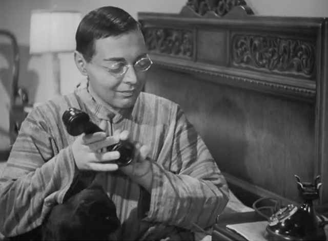 Think Fast, Mr. Moto - Mr. Moto Peter Lorre picking up telephone receiver with black cat Chunkina on lap