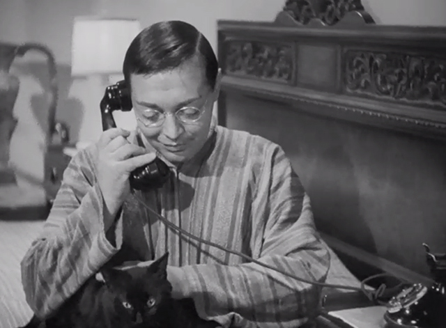 Think Fast, Mr. Moto - Mr. Moto Peter Lorre on phone while petting black cat Chunkina