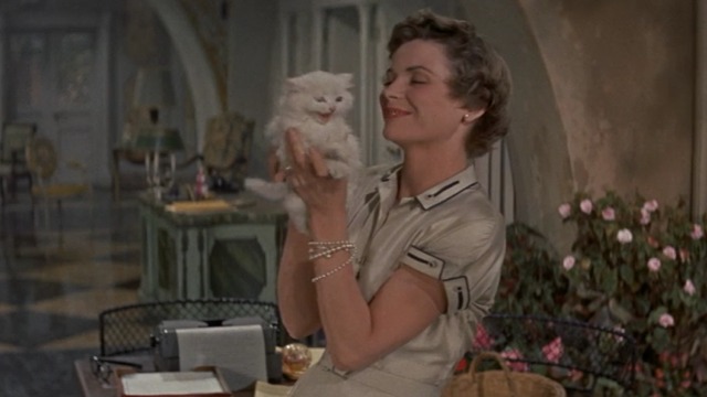 Three Coins in the Fountain - Frances holding up white Angora kitten