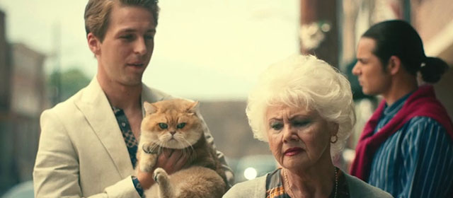 The Toxic Avenger - Daisy Annette Badland with Spence Abraham Lewis holding golden British shorthair cat Mr. Treats