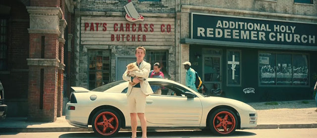 The Toxic Avenger - Spence Abraham Lewis holding golden British shorthair cat Mr. Treats outside car