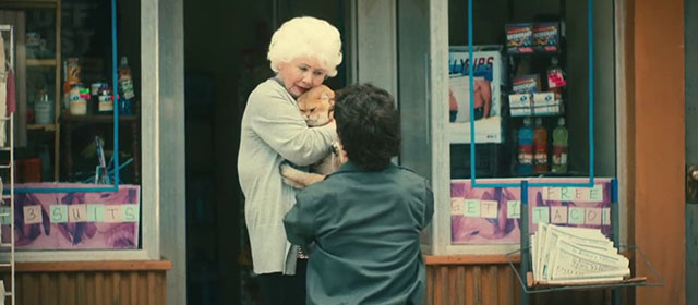 The Toxic Avenger - Daisy Annette Badland holding golden British shorthair cat Mr. Treats with Winston Peter Dinklage