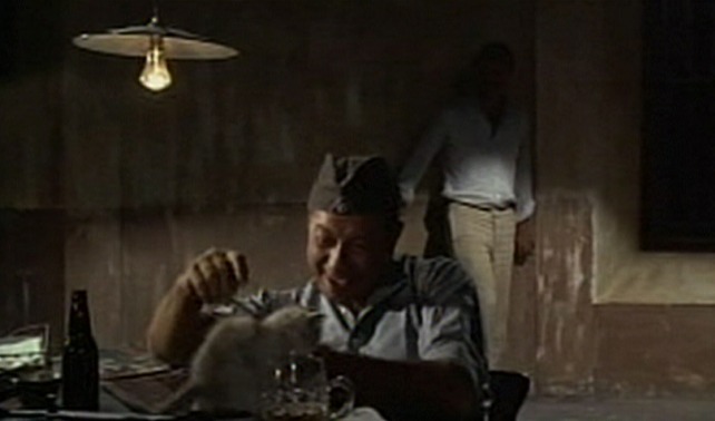 Triple Cross - guard plays with kitten on desk while Eddie Chapman tries to sneak by